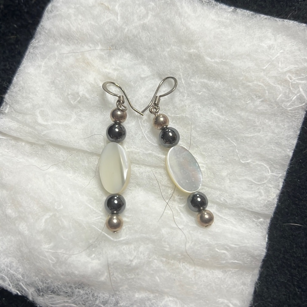 White stone and black pearls